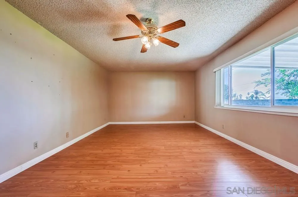5970 Eucalyptus Drive Highland, CA 92346 - Photo 5 of 26 wooden floor in an empty room with a window