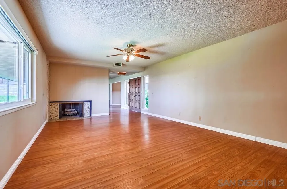 5970 Eucalyptus Drive Highland, CA 92346 - Photo 6 of 26 wooden floor in an empty room with a window