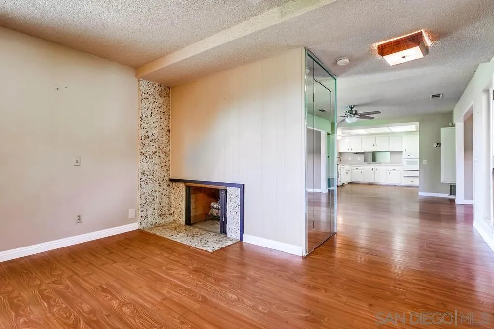 5970 Eucalyptus Drive Highland, CA 92346 - Photo 7 of 26 a view of empty room with wooden floor and fireplace
