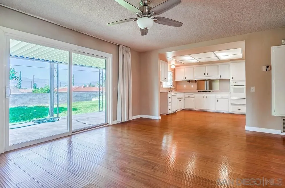 5970 Eucalyptus Drive Highland, CA 92346 - Photo 8 of 26 a view of empty room with wooden floor and fan