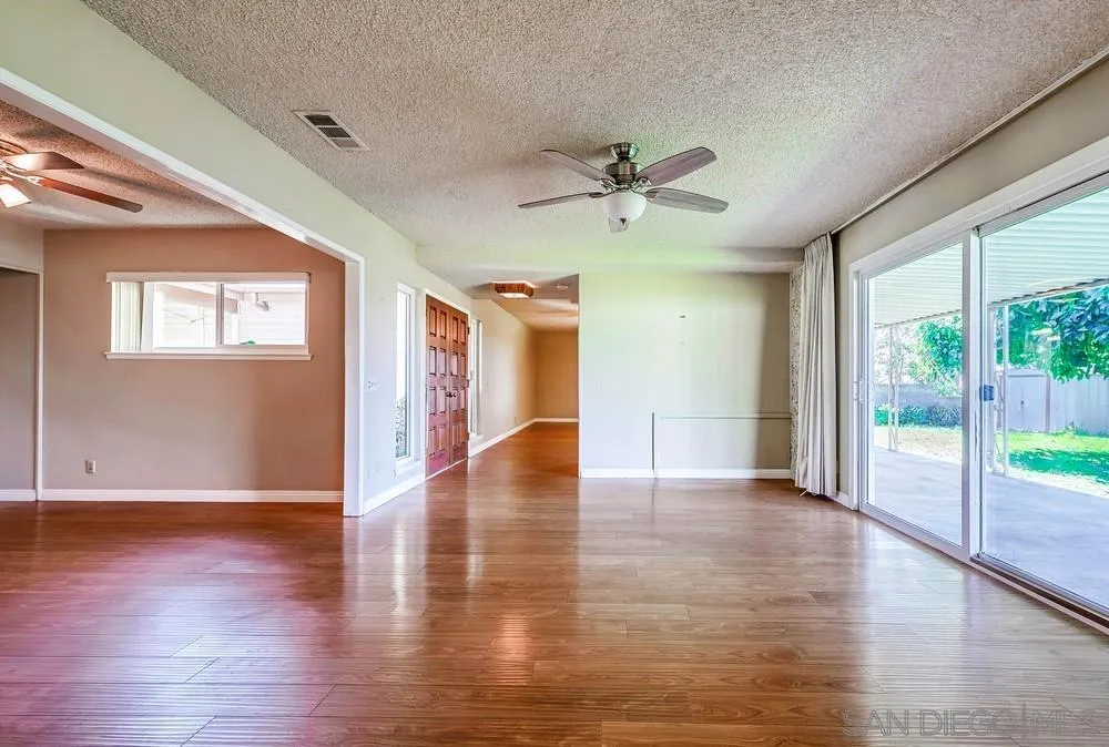 5970 Eucalyptus Drive Highland, CA 92346 - Photo 10 of 26 a view of an empty room with wooden floor and a window