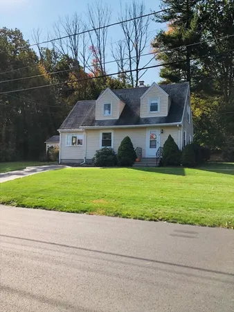 a front view of house with yard and green space