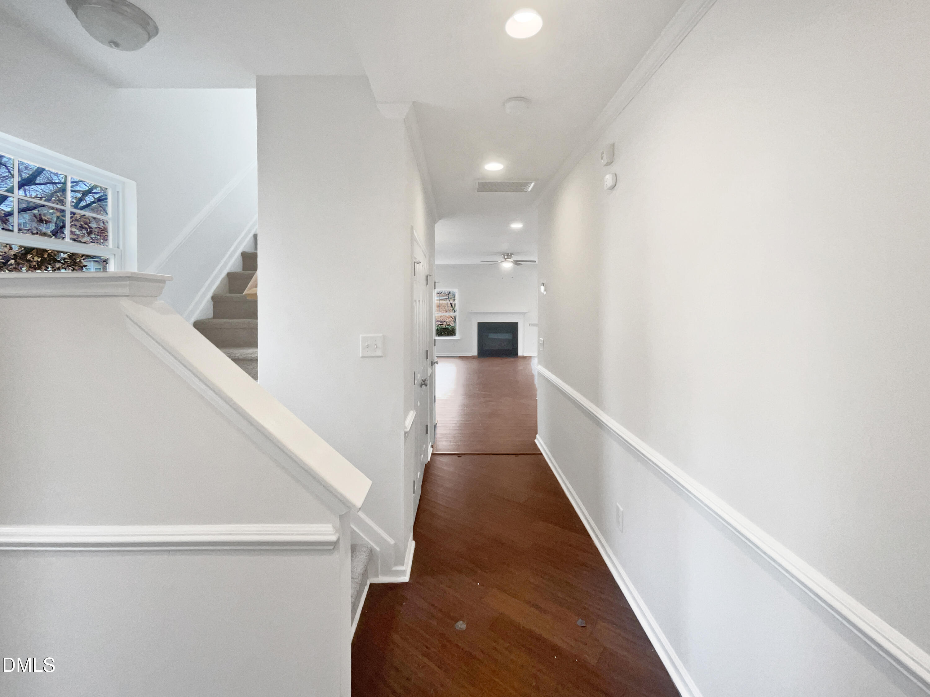 1301 Stone Manor Drive Raleigh, NC 27610 - Photo 7 of 16 a view of a hallway with wooden floor