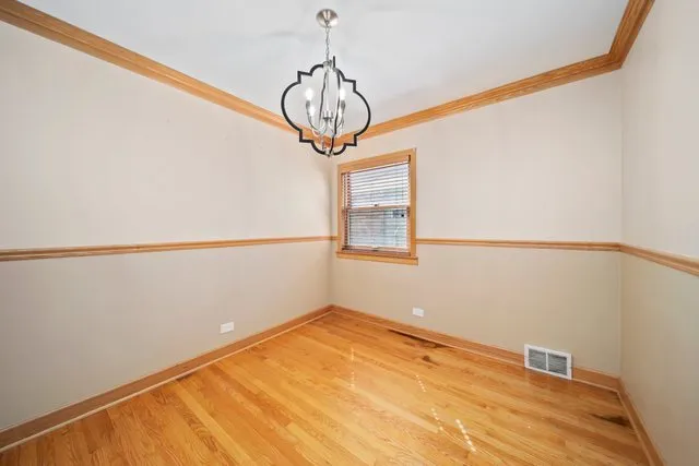 a view of a room with wooden floor and white walls