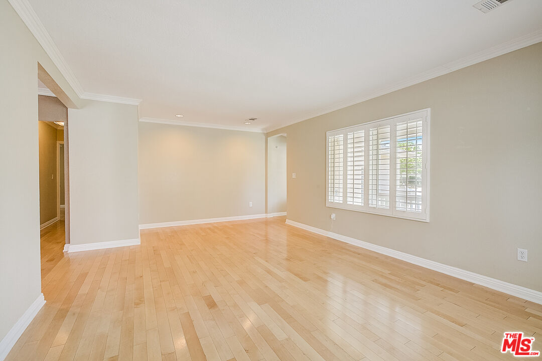 11038 Rhodesia Avenue Sunland, CA 91040 - Photo 11 of 36 a view of an empty room with wooden floor and a window