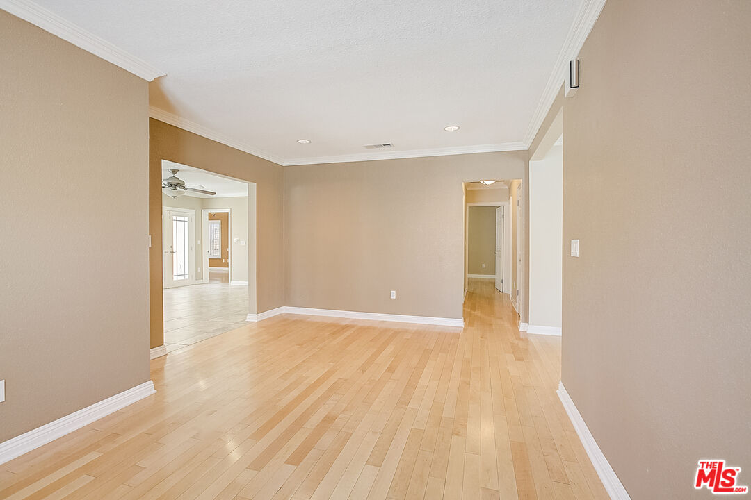 11038 Rhodesia Avenue Sunland, CA 91040 - Photo 12 of 36 a view of an empty room with wooden floor