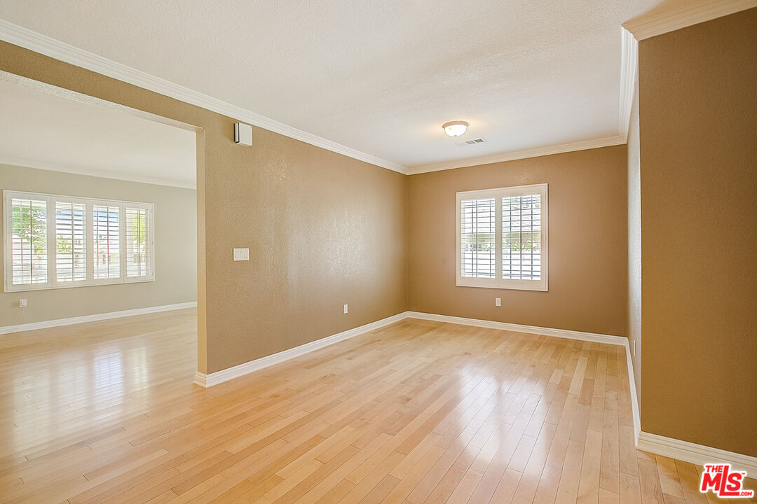 11038 Rhodesia Avenue Sunland, CA 91040 - Photo 13 of 36 a view of an empty room with wooden floor and a window