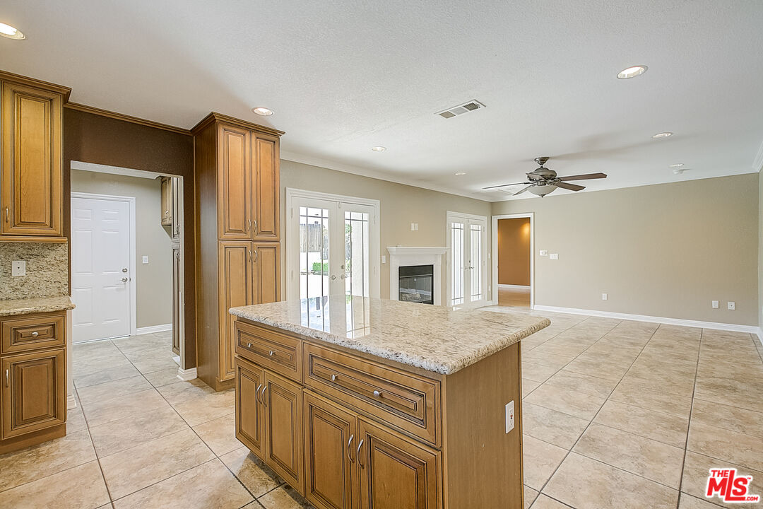 11038 Rhodesia Avenue Sunland, CA 91040 - Photo 15 of 36 a bathroom with a granite countertop sink a mirror and a shower