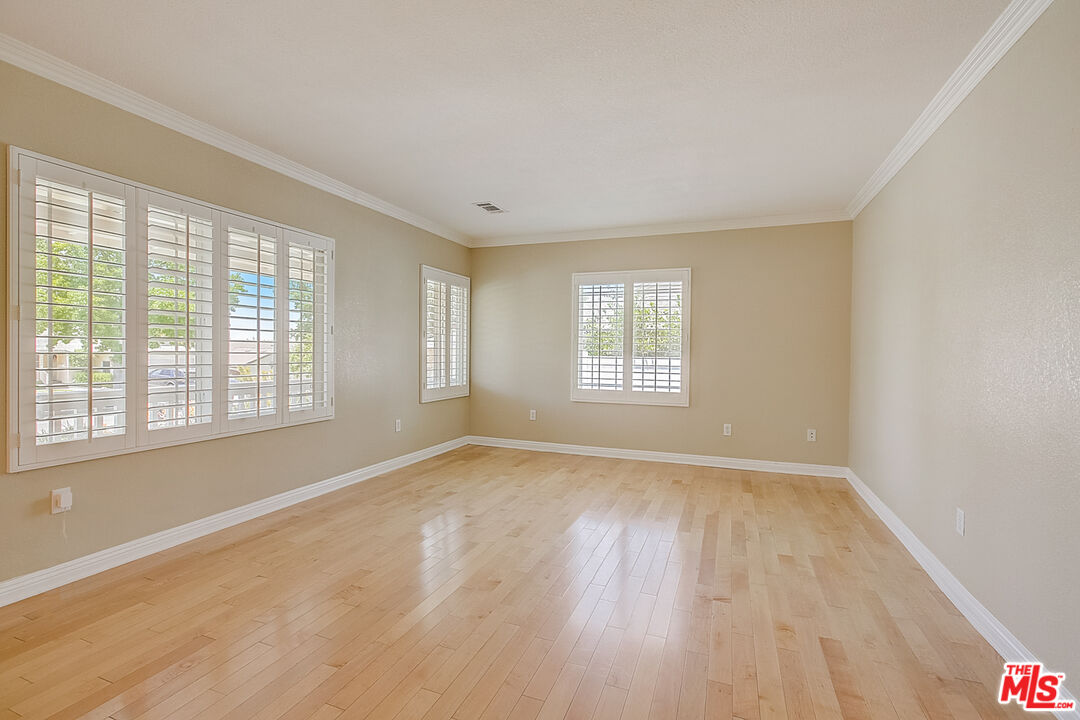 11038 Rhodesia Avenue Sunland, CA 91040 - Photo 16 of 36 an empty room with wooden floor and windows