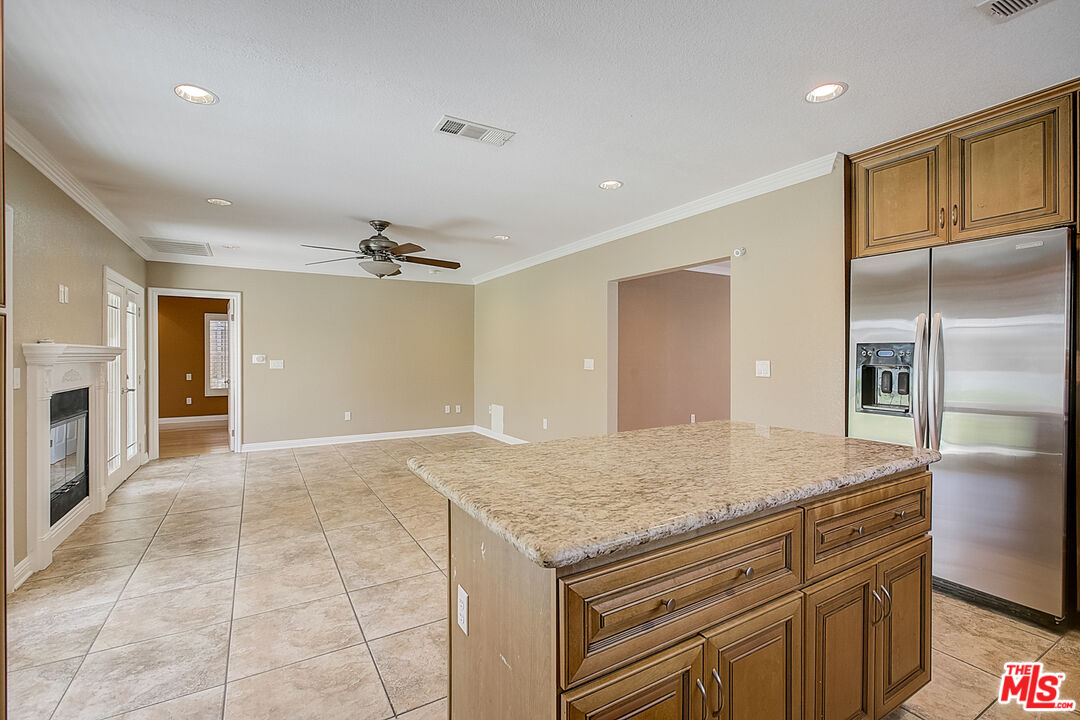 11038 Rhodesia Avenue Sunland, CA 91040 - Photo 17 of 36 a kitchen with granite countertop a refrigerator and chandelier