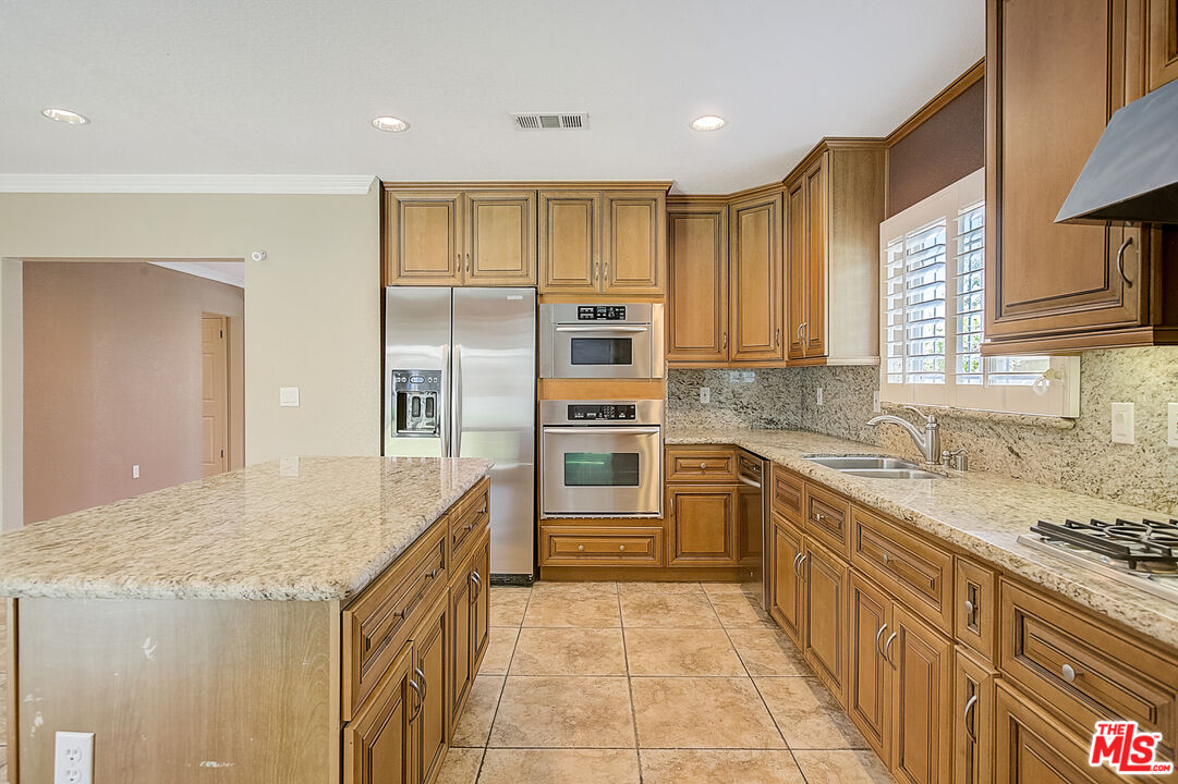 11038 Rhodesia Avenue Sunland, CA 91040 - Photo 18 of 36 a kitchen with stainless steel appliances granite countertop a stove and a sink