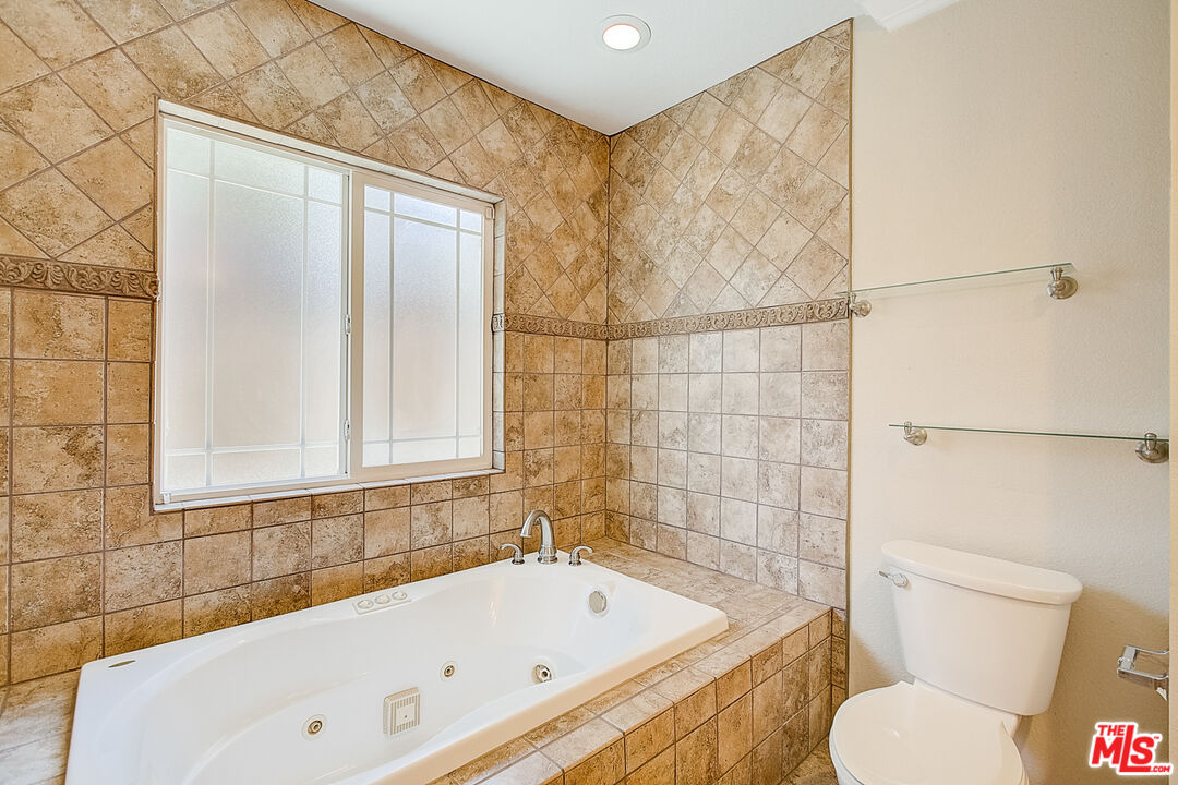 11038 Rhodesia Avenue Sunland, CA 91040 - Photo 26 of 36 a bathroom with a bathtub and a toilet