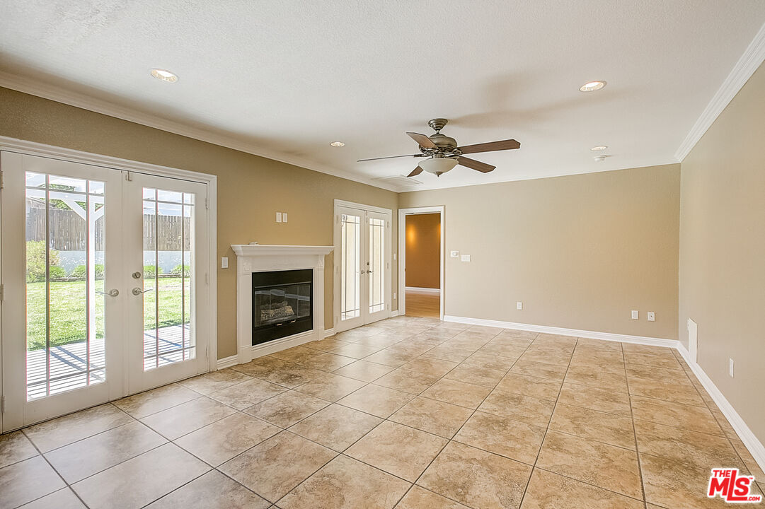 11038 Rhodesia Avenue Sunland, CA 91040 - Photo 5 of 36 a view of an empty room with a fireplace and a window