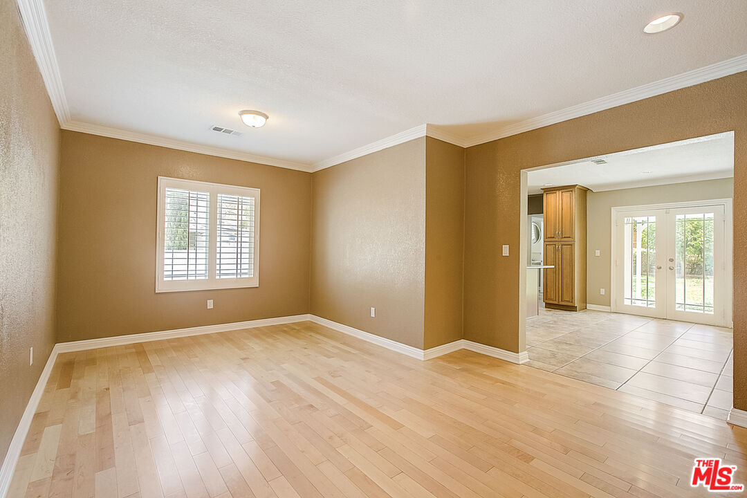 11038 Rhodesia Avenue Sunland, CA 91040 - Photo 9 of 36 a view of an empty room with glass door and wooden floor