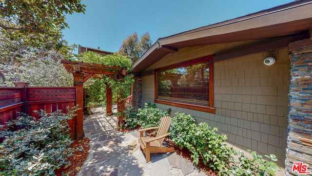 a living room with furniture a flat screen tv and a large window