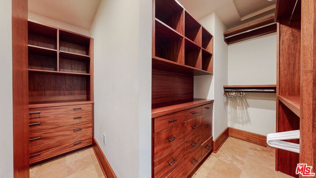 a bathroom with a granite countertop double vanity sink and a mirror
