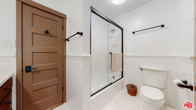 a view of storage and utility room with closet