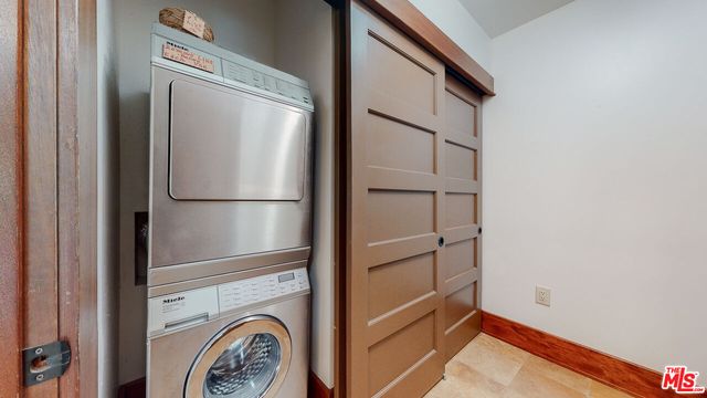 a living room with a table and a rug