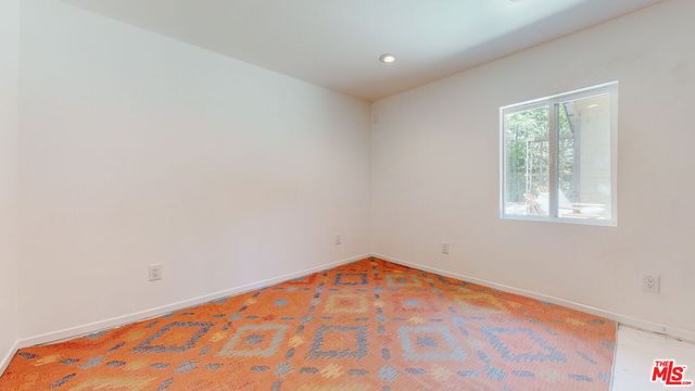a view of backyard with outdoor seating and plants