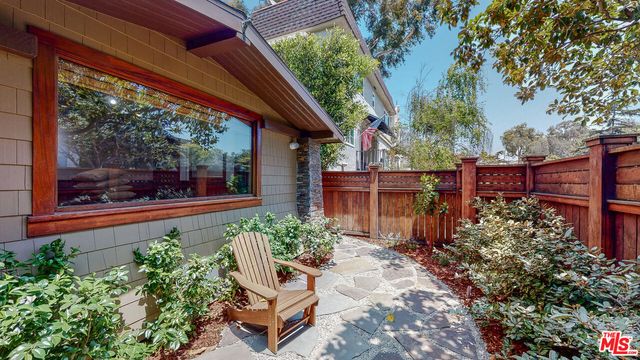 a living room with furniture a fireplace and a floor to ceiling window