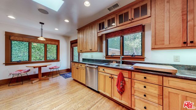 a backyard with potted plants and a large tree