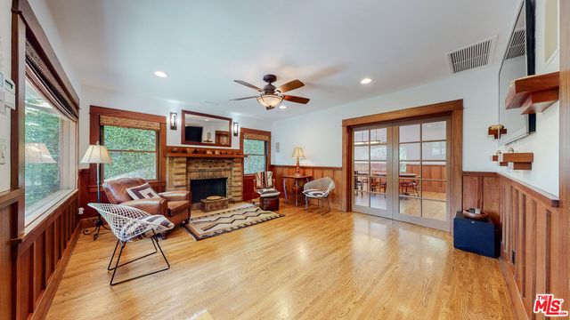 a dining room with furniture a chandelier and wooden floor