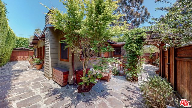 a kitchen with granite countertop wooden cabinets a sink and dishwasher