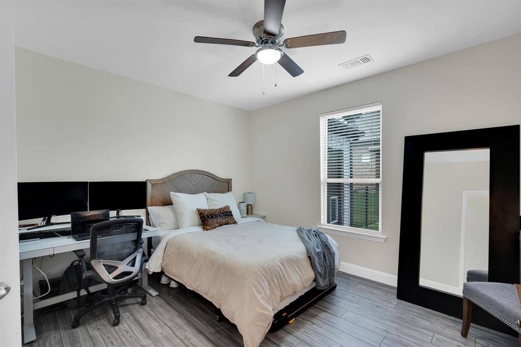 1601 Bear Path Way Gunter, TX 75058 - Photo 25 of 40 a bedroom with a bed and wooden floor