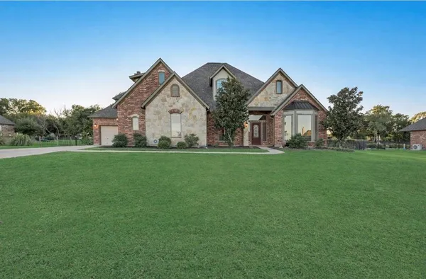 a front view of house with yard and green space