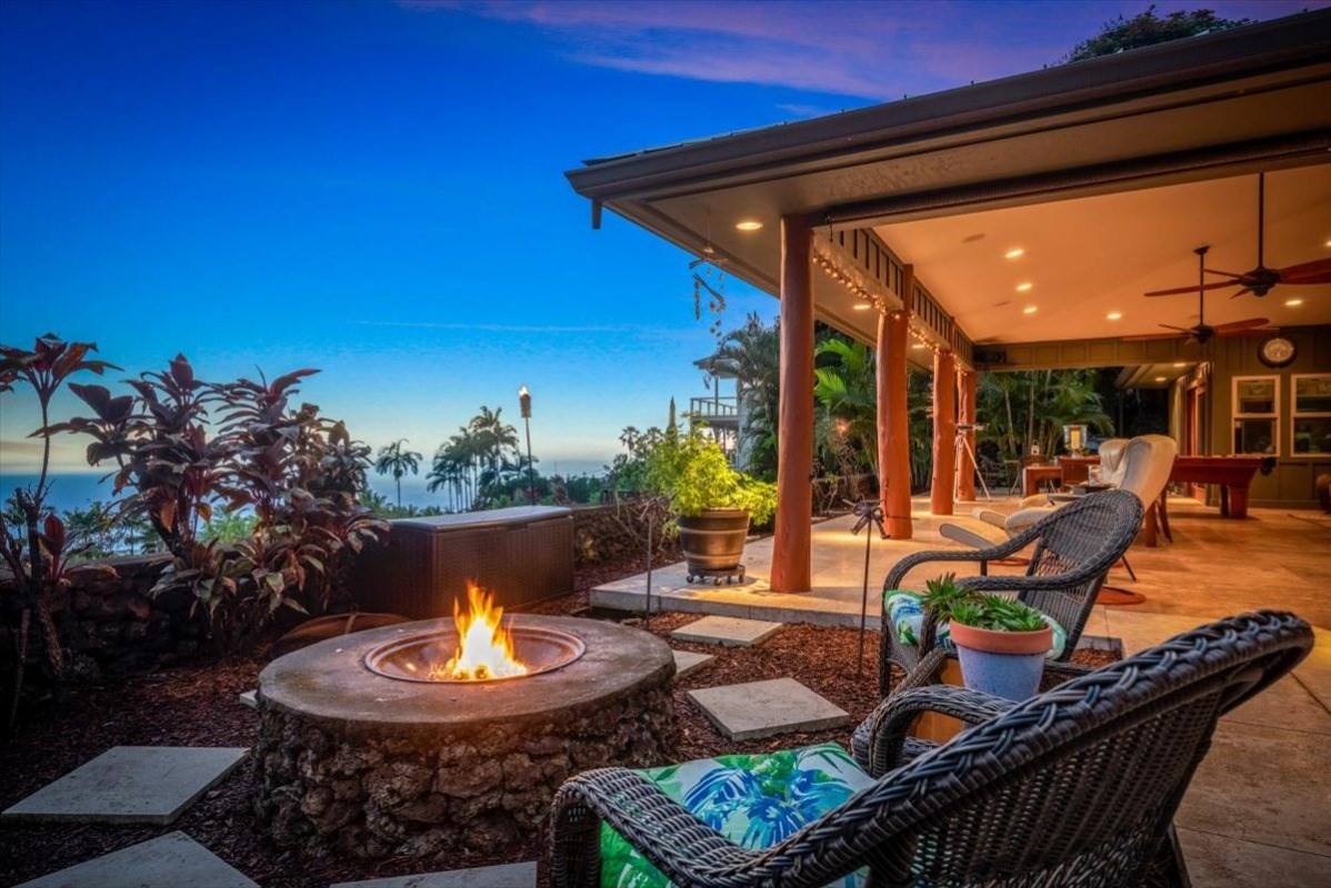 a view of a porch with furniture and a fire pit
