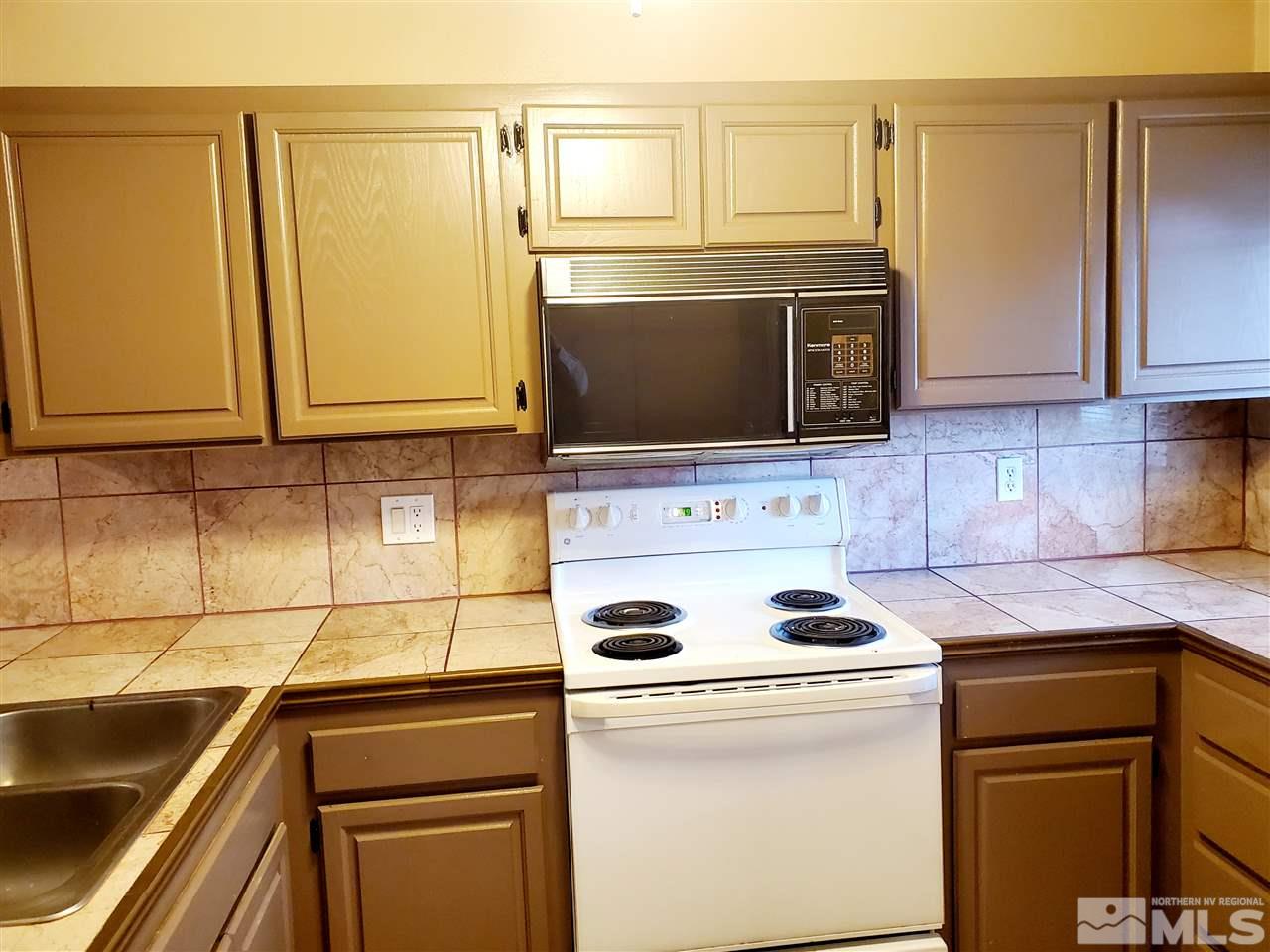 2929 Tierra Verde East Reno, NV 89512 - Photo 4 of 10 a kitchen with granite countertop cabinets stainless steel appliances and a sink