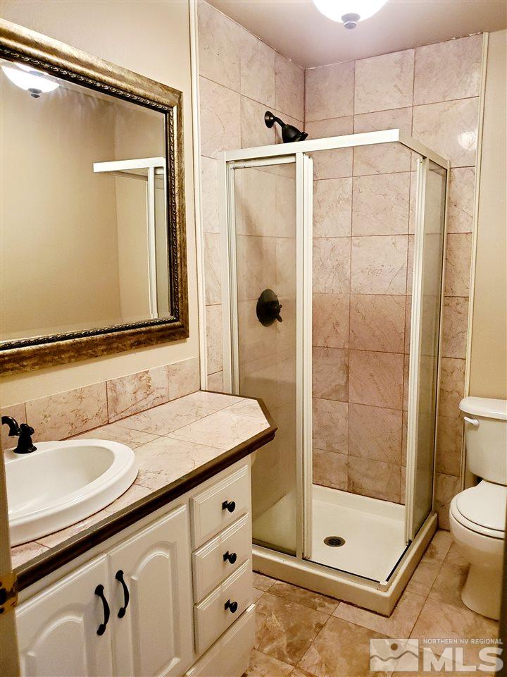 2929 Tierra Verde East Reno, NV 89512 - Photo 8 of 10 a bathroom with a shower a sink and mirror