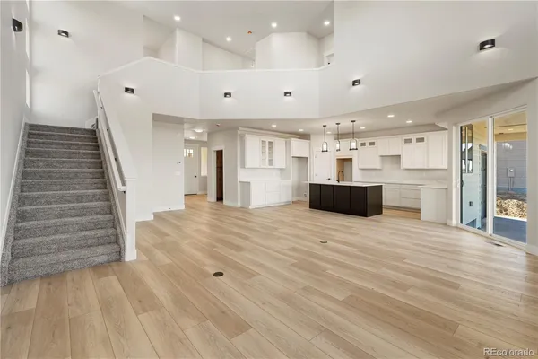a view of a kitchen with cabinets and wooden floor