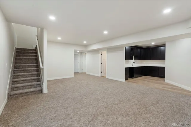 a living room with furniture kitchen view and a chandelier