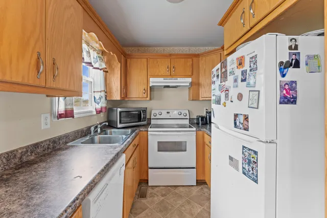 a kitchen with a refrigerator a sink and dishwasher