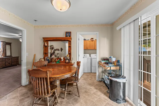 a dining room with furniture and window