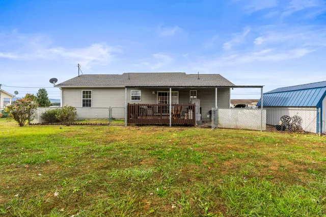 a view of a house with backyard porch and garden