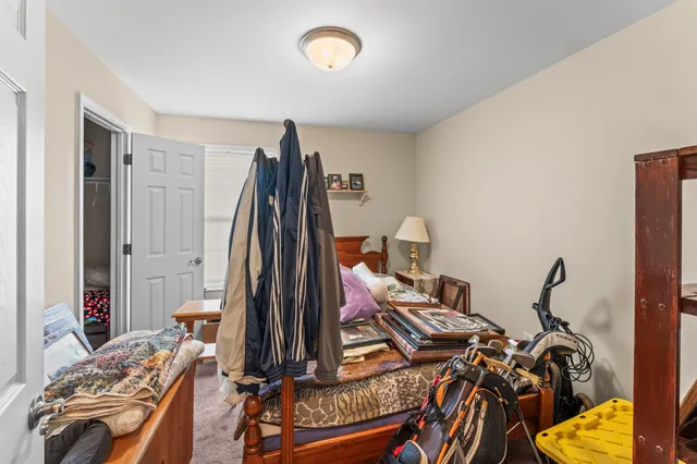 a view of a bedroom with bed and mirror