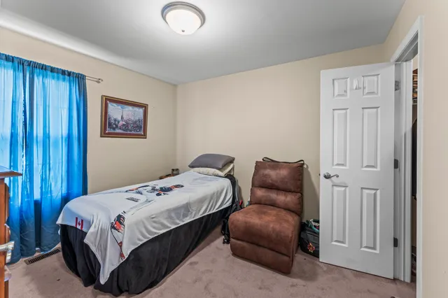 a bedroom with a bed and a couch