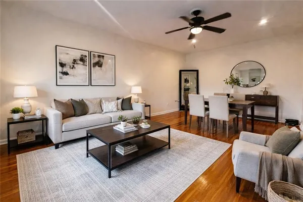 a living room with furniture a rug and a chandelier