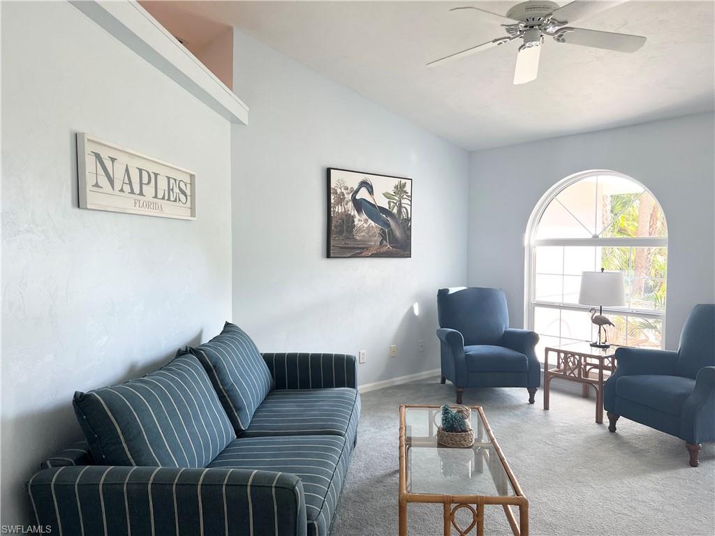 3221 64th Street Southwest Naples, FL 34105 - Photo 3 of 12 Living room with vaulted ceiling and ceiling fan