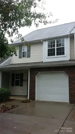 a front view of a house with a parking space