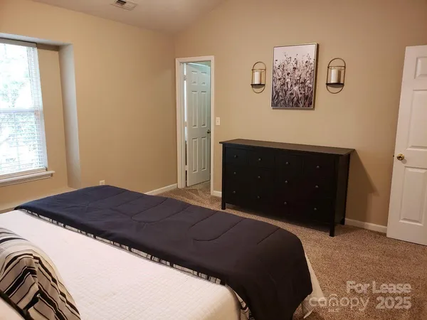 a bedroom with a bed and wall painting