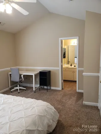 a bedroom with a bed and a desk