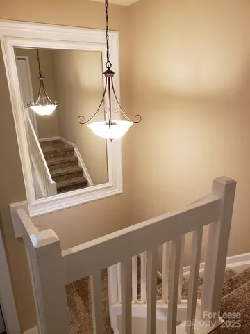 a view of a hallway with a chandelier