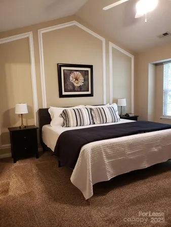 a bedroom with a bed and a couch