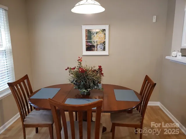 a view of a dining room with furniture and window