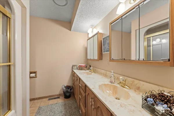 a bathroom with a double vanity sink and a mirror