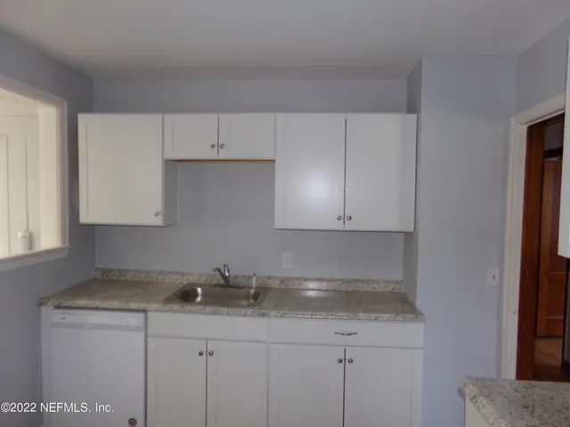 a kitchen with a sink and cabinets