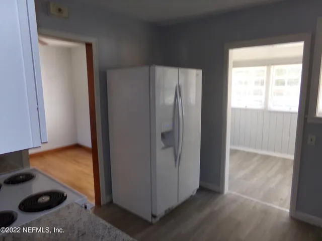 a kitchen with stainless steel appliances granite countertop a stove a refrigerator and a sink